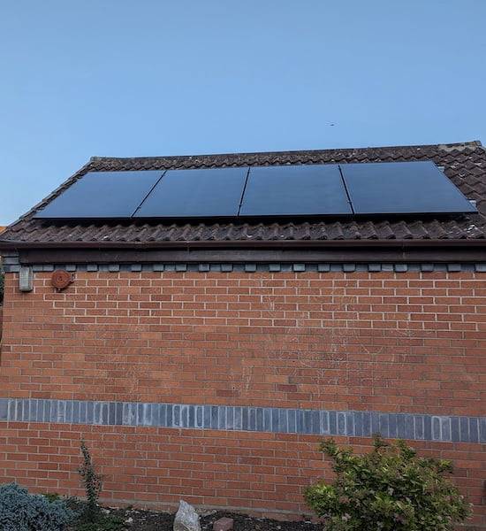 A picture of solar panels on a single storey building. The emphasis is on how the perspective skews our way of perceiving the real size of the object.