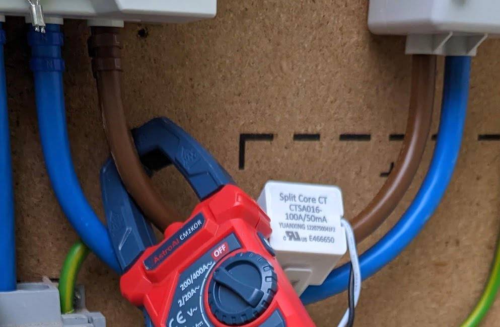 Photograph of somewhat obscured CT clamp connected to meter tails.