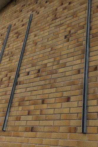 unistrut on wall Photograph of unistrut rails installed on a wall. The wall is brick there is nothing on the unistrut rails yet.